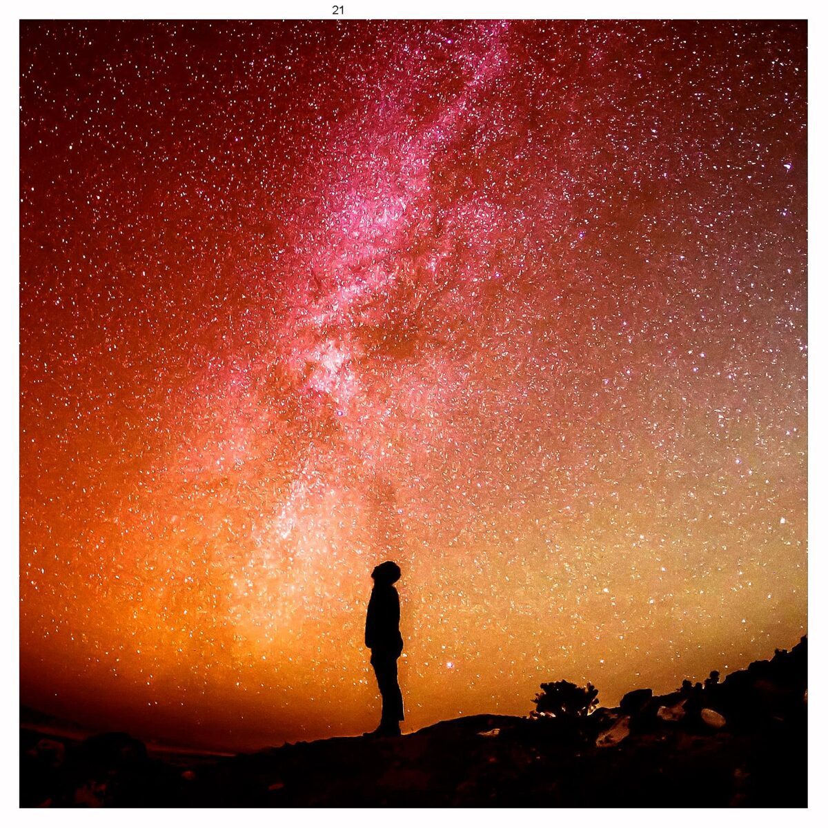 Silhouette of a person gazing at the Milky Way in a vibrant starry sky, framed in an energy-efficient LED Box Frame."